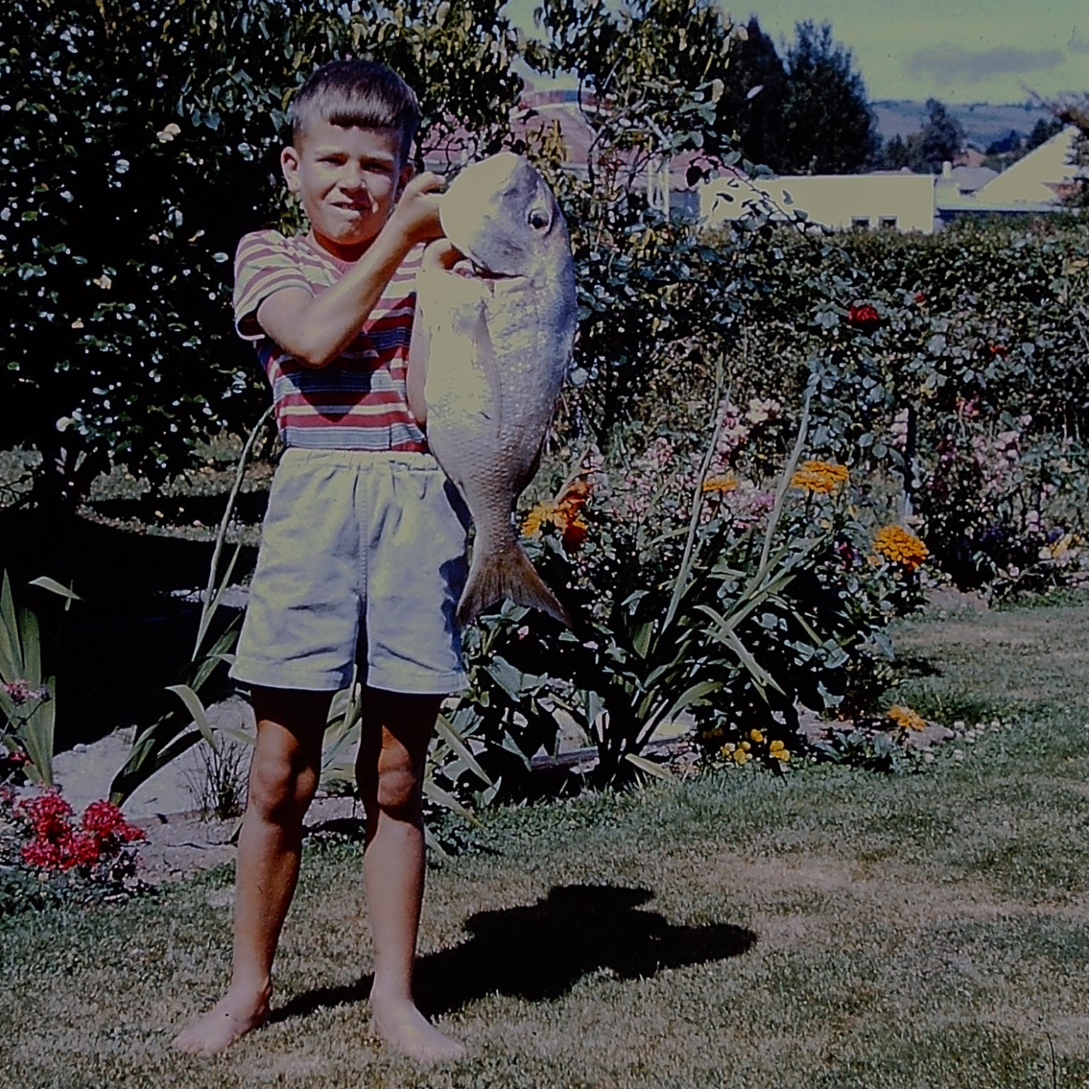 Young Ian proudly holding a fish